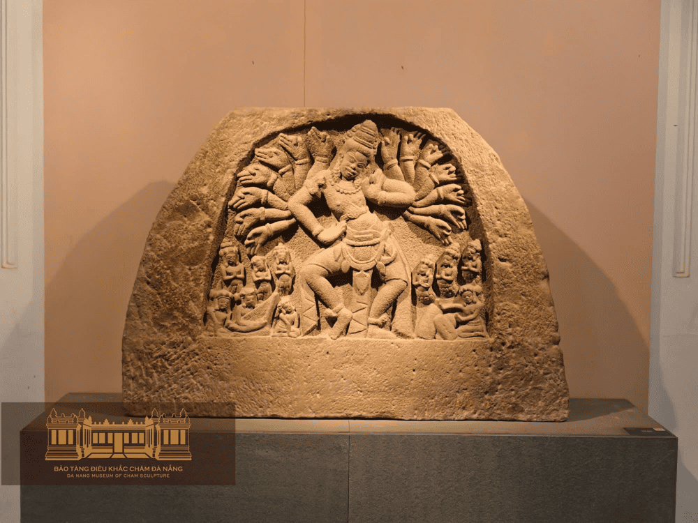 A multi-armed deity in dynamic form, an iconic Cham sandstone relief from the 10th century (Source: Bảo tàng Điêu khắc Chăm Đà Nẵng - Da Nang Museum of Cham Sculpture)